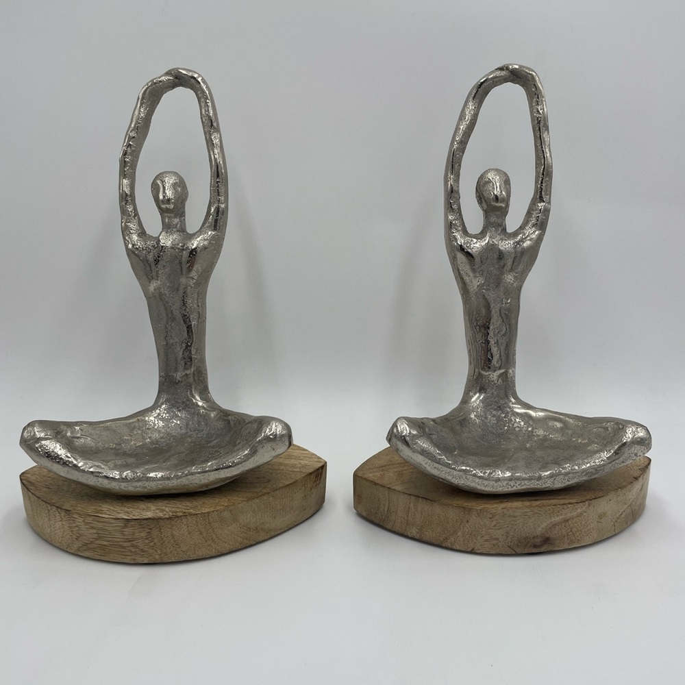 2 silver metal yoga figurines.
